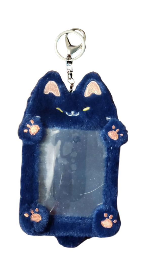 Blue cat-shaped keychain with a clear panel on a wooden surface